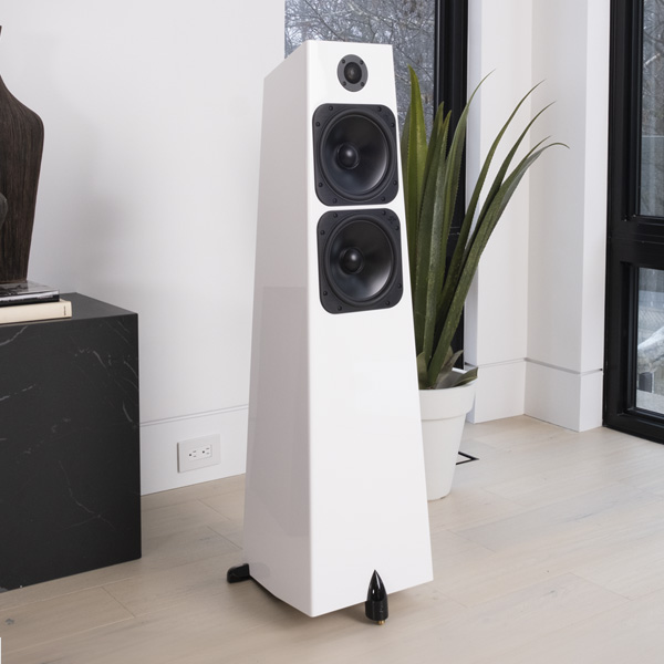 Element Metal V2 in Ice gloss white beside a tall window, a snake plant and a dark stone plinth behind it on a pale wood floor