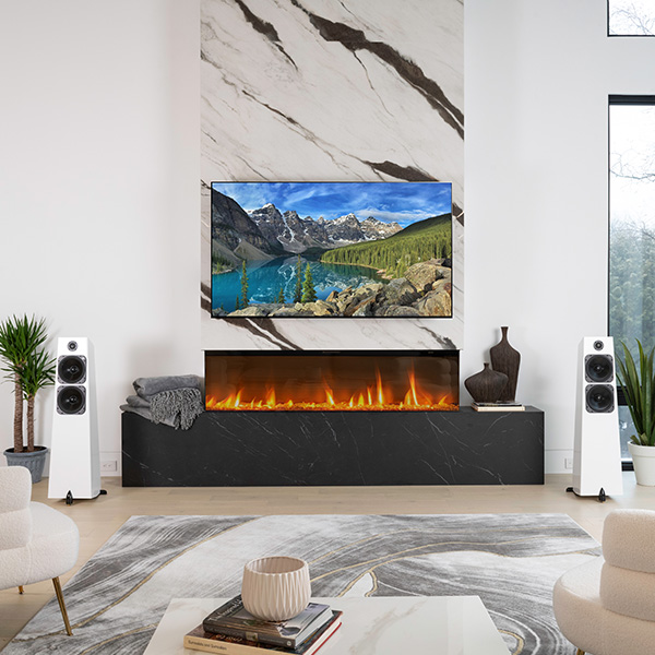 A pair of Element Metal V2 in Ice gloss white flanking a marble fireplace wall with a wide TV above a long linear fire, a low table and rug in the foreground