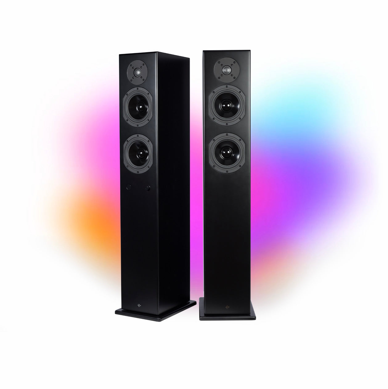 The Kin Play Tower II pair in satin black, grilles off, against a coloured glow: two five-inch woofers under the dome on each slim, metre-tall column