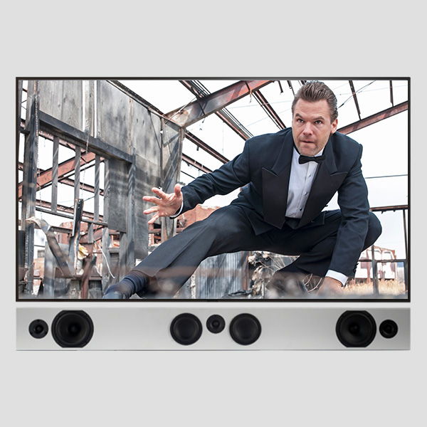 Tribe Trio in Satin White under a wall-mounted screen: left, centre and right channels in one bar
